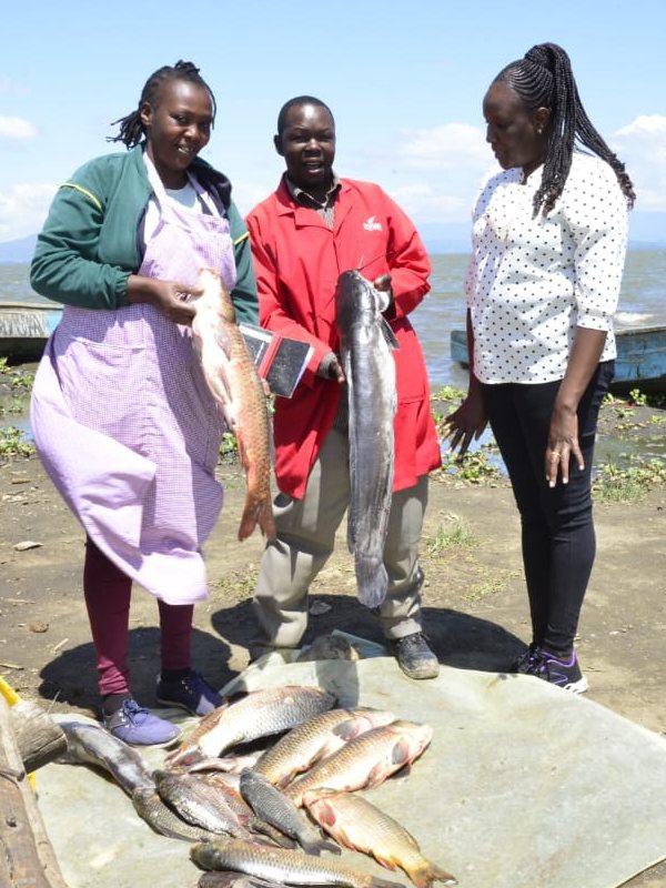 Fish traders with their fresh catch by the lake